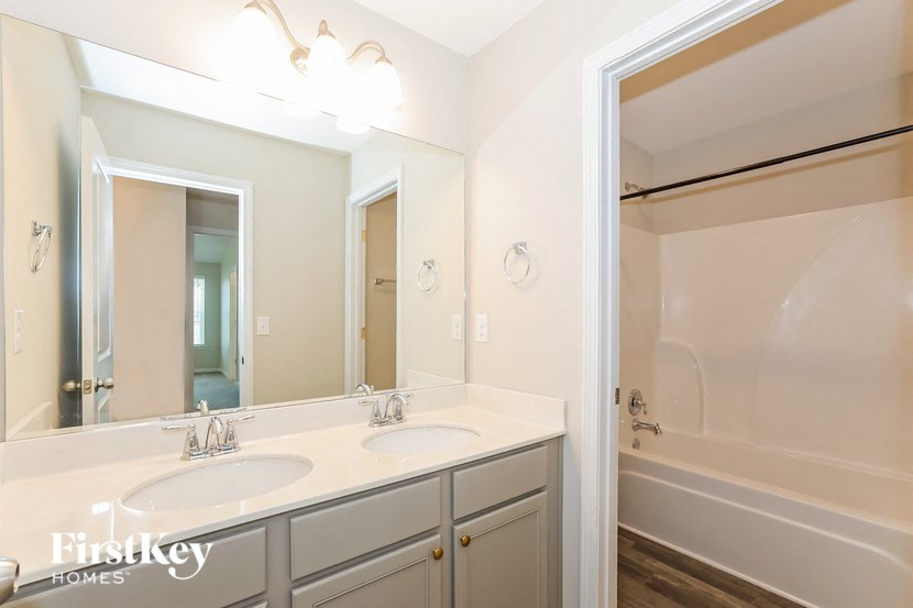 a bathroom with two sinks and a large mirror