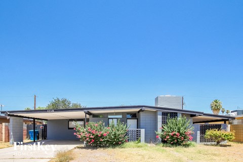 a small house with a blue sky above it