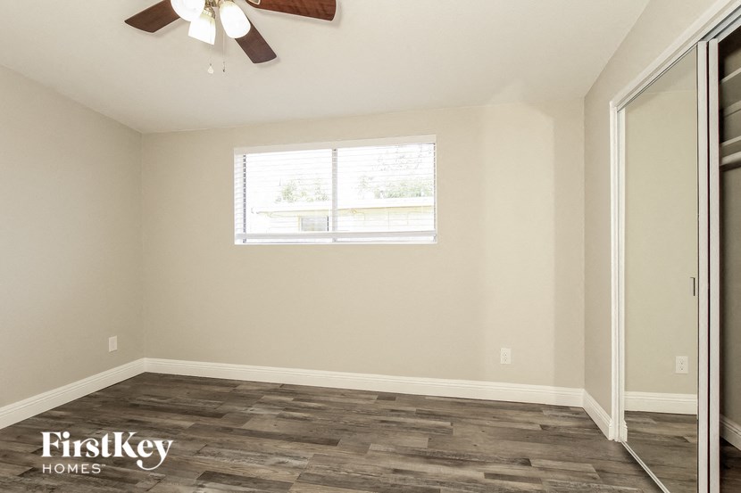 a empty room with a window and a ceiling fan