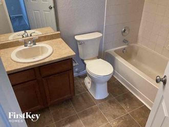 a bathroom with a sink toilet and a bath tub