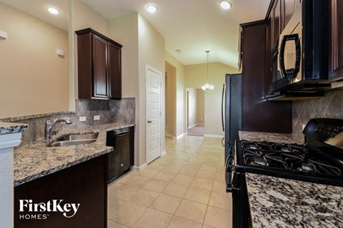 a kitchen with black appliances and granite counter tops