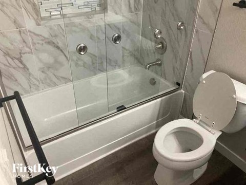 a bathroom with a toilet and a glass shower