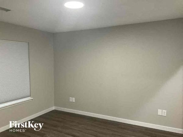 an empty room with white walls and a window