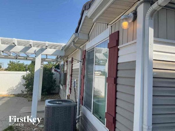 the side of a house with a porch and a radiator