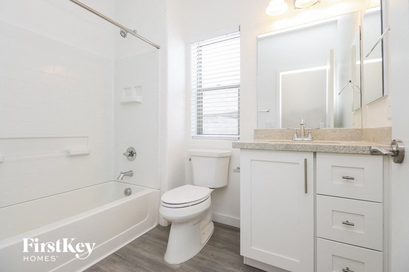 a bathroom with a toilet and a tub and a sink