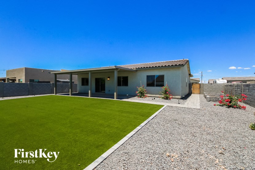 a house with a green lawn and a blue sky