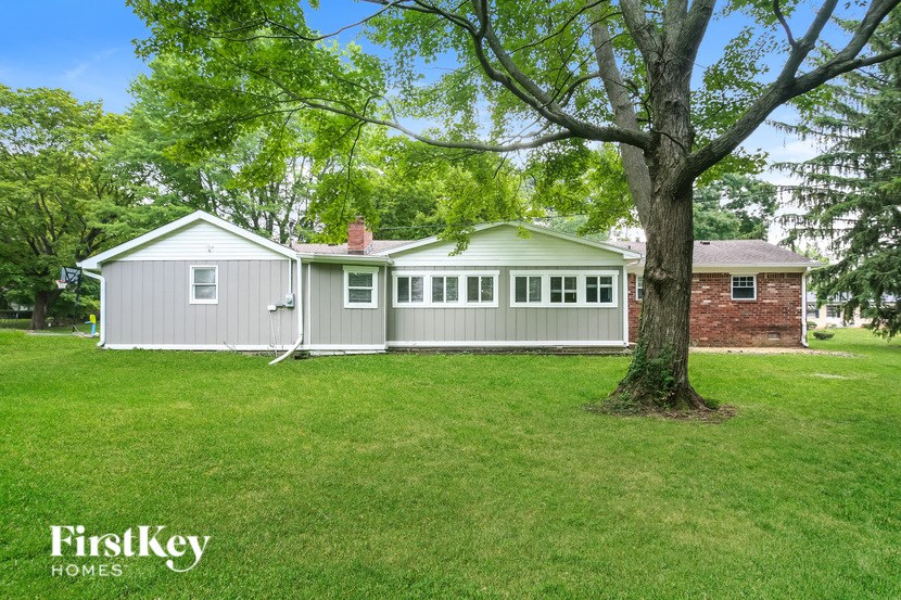A house with a tree in front of it.