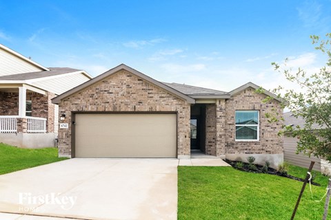 a garage door in front of a brick house