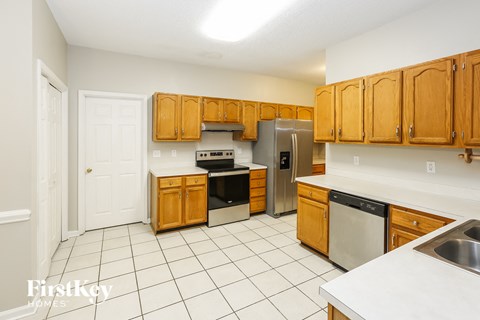 a kitchen with wooden cabinets and stainless steel appliances