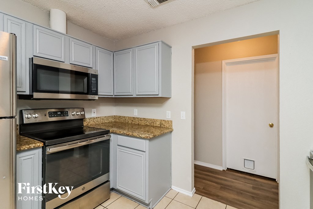 a kitchen with stainless steel appliances and granite counter tops