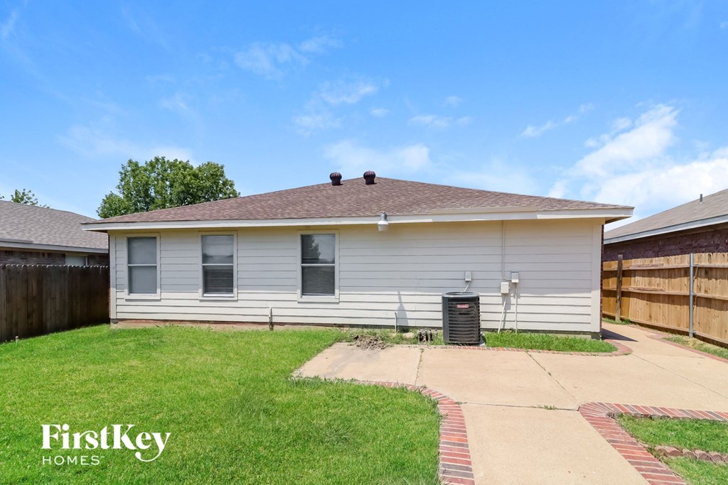 a small white house with a yard in front of it