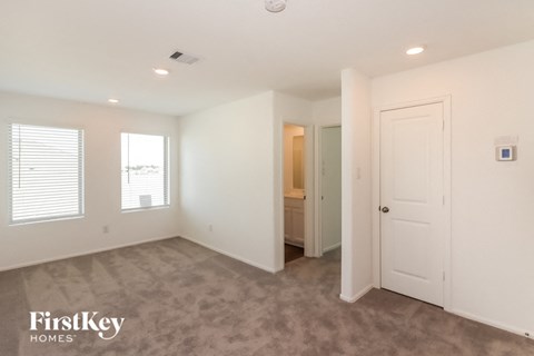 a bedroom with a closet and a door to a bathroom