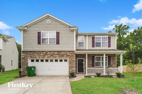 A two-story house with a garage and a front porch.