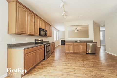 A kitchen with wooden cabinets and a stainless steel dishwasher.