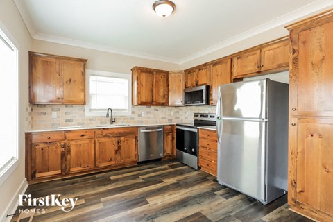 a kitchen with wooden cabinets and stainless steel appliances