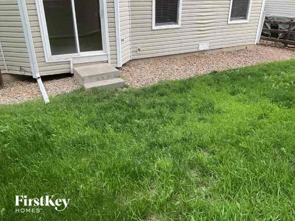 a yard with grass in front of a house