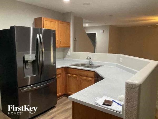 a kitchen with a stainless steel refrigerator and a sink