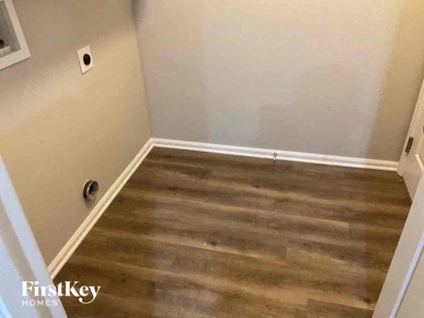 a room with wooden floors and a white wall