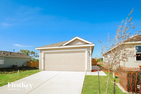 a home with a garage door and a driveway