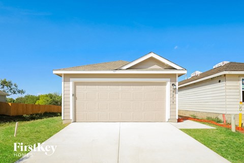 a home with a garage door and a driveway