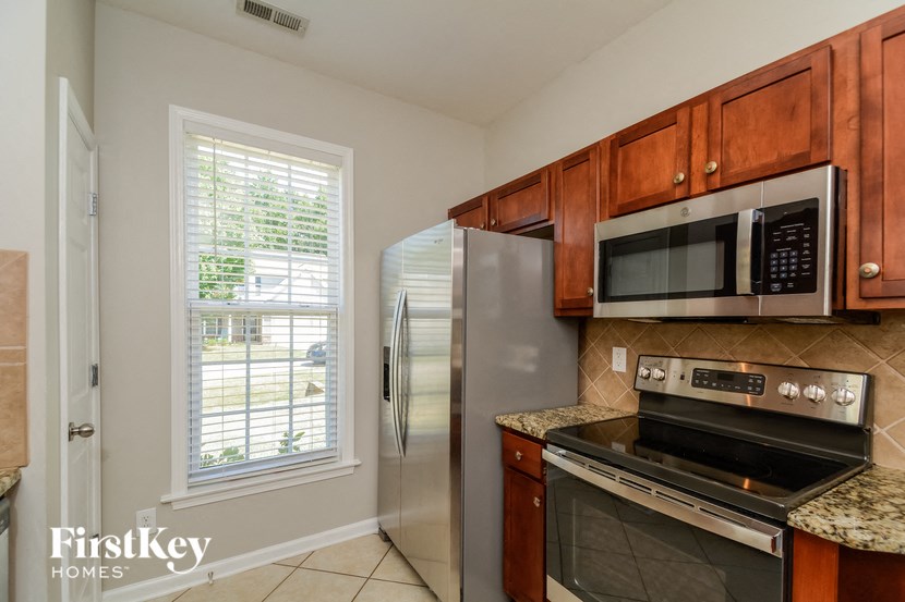 a kitchen with stainless steel appliances and wooden cabinets