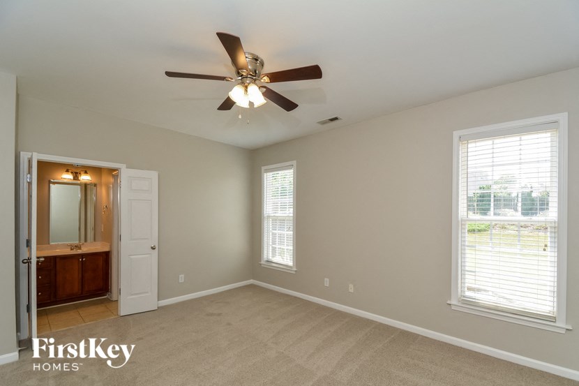 the master bedroom is spacious and has a ceiling fan