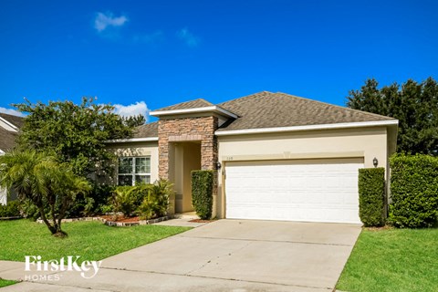 a house with a white garage door and a lawn