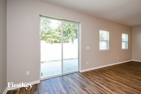 a living room with wood floors and a sliding glass door