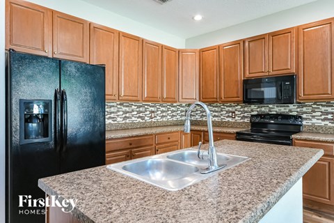 a kitchen with a sink and a refrigerator