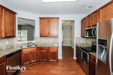 a kitchen with wooden cabinets and stainless steel appliances