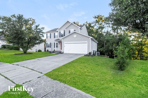 a white house with a white garage door and a driveway