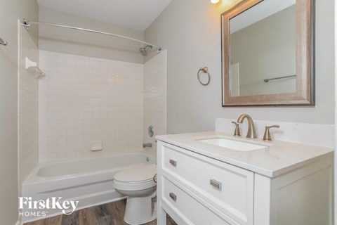 a bathroom with a sink toilet and a bath tub