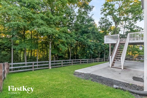 the stairs to the playground are next to a fence