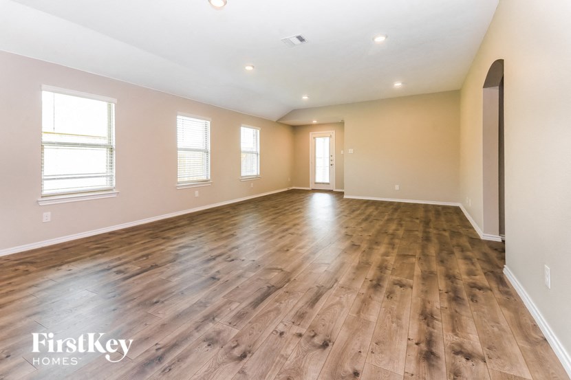 the living room and dining room with hardwood flooring