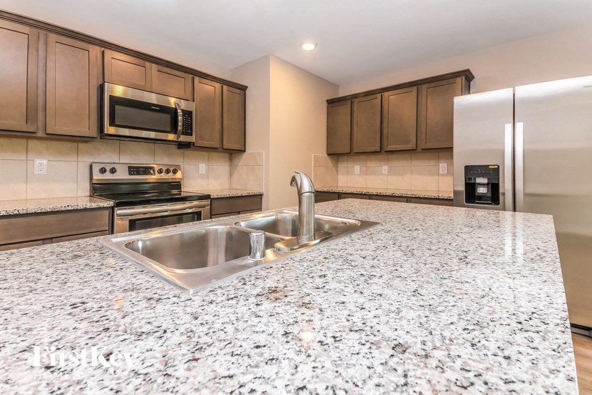 a kitchen with stainless steel appliances and granite counter tops