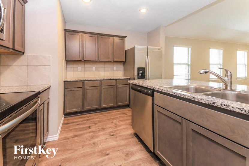 a kitchen with stainless steel appliances and wooden counter tops
