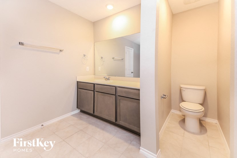 a bathroom with a toilet and a sink and a mirror