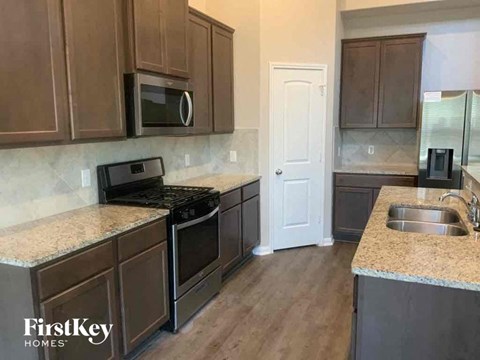 a kitchen with wooden cabinets and stainless steel appliances
