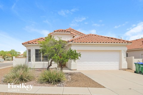a home with a white garage door and a driveway