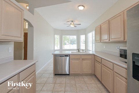 a kitchen with wooden cabinets and a stainless steel dishwasher