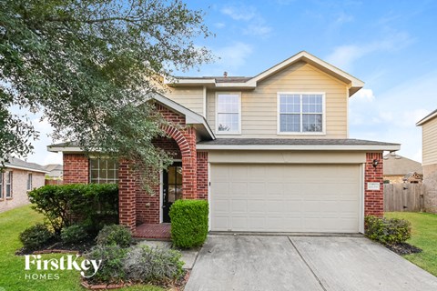 the front exterior of a house with a garage door
