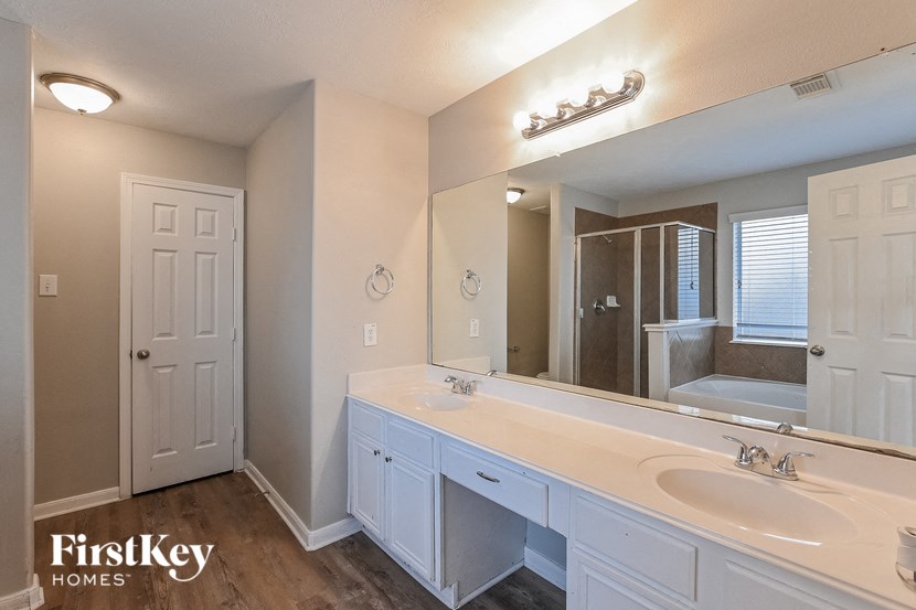 a bathroom with a large mirror and two sinks