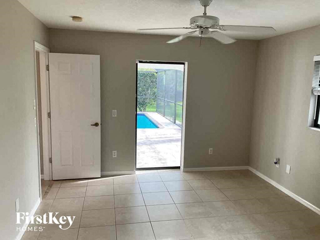 A room with a sliding glass door leading to a pool.