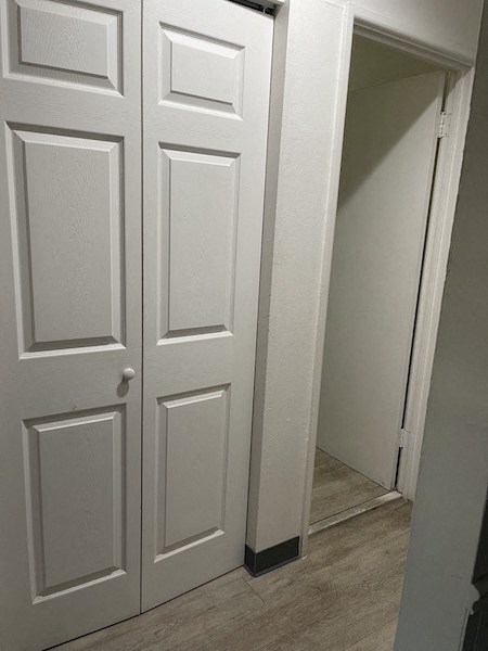 a white door in a room with a staircase