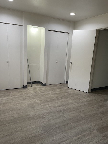 an empty room with white walls and doors