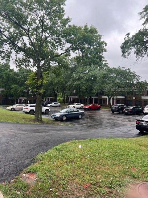 a parking lot filled with cars in front of a building