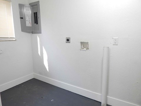 a white wall with two outlets and a window