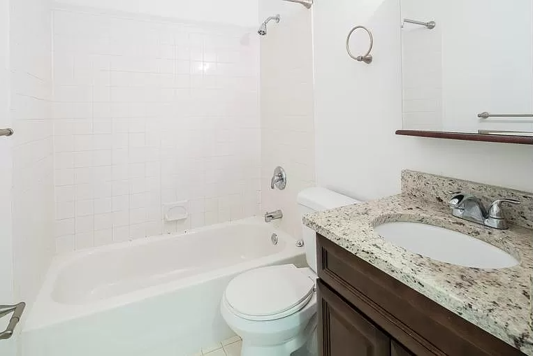 a bathroom with a sink toilet and bath tub