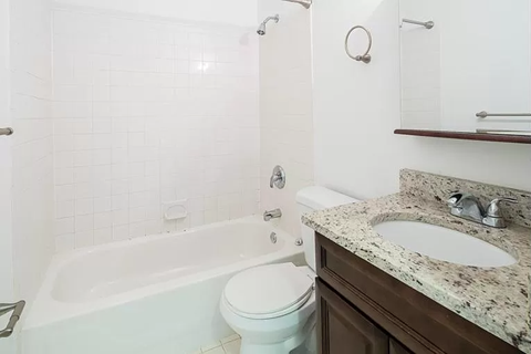 a bathroom with a sink toilet and bath tub