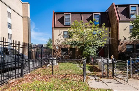 a yard with a fence in front of a house